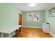 Bright bedroom with hardwood floors, a desk, and ample natural light from the windows at 1714 Park Dr, Raleigh, NC 27605