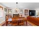 Formal dining room featuring hardwood floors, stylish lighting, and comfortable seating at 1714 Park Dr, Raleigh, NC 27605
