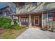 Inviting front porch featuring stone supports, a wooden ceiling, and a red front door at 1714 Park Dr, Raleigh, NC 27605