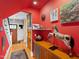 Eclectic hallway featuring red walls, hardwood floors, and unique decor at 1714 Park Dr, Raleigh, NC 27605