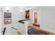 Bright hallway with hardwood floors and decorative artwork leading to the bathroom at 1714 Park Dr, Raleigh, NC 27605