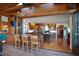 Spacious sunroom with a bar, lounge area, and doors opening to the kitchen and living room at 1714 Park Dr, Raleigh, NC 27605