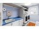 Functional laundry room with modern appliances, custom cabinets, and ample counter space at 1714 Park Dr, Raleigh, NC 27605