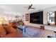 Cozy living room with hardwood floors, comfortable sofas, and large flat screen TV at 1714 Park Dr, Raleigh, NC 27605