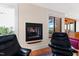 Cozy reading area with fireplace and comfortable seating by the window at 1714 Park Dr, Raleigh, NC 27605