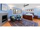 Stylish bedroom with a fireplace, sitting area, ceiling fan, and plush rug at 1714 Park Dr, Raleigh, NC 27605