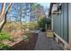 Grassy side yard with retaining wall, metal planters, and small wood deck offers space for gardening and outdoor enjoyment at 1714 Park Dr, Raleigh, NC 27605