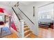 Stylish staircase featuring wooden steps, white risers, and an adjacent sitting area at 1714 Park Dr, Raleigh, NC 27605