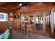 Sunroom with wooden ceiling, bar, lounge area, and doors opening to the kitchen at 1714 Park Dr, Raleigh, NC 27605
