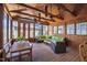 Inviting sunroom with wood paneled ceiling, dining table, and comfortable seating at 1714 Park Dr, Raleigh, NC 27605