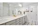 A modern bathroom with dual sinks, white cabinets, and decorative floor tiles at 236 Annabelle Blue Dr, Wake Forest, NC 27587