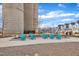 Community common area with Adirondack chairs, concrete seating, and towering silo structures on a sunny day at 236 Annabelle Blue Dr, Wake Forest, NC 27587