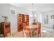 Elegant dining room featuring a wooden table, stylish chandelier, and cozy built-in bookshelves at 236 Annabelle Blue Dr, Wake Forest, NC 27587