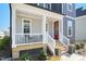 Inviting front porch with a red door and decorative flower pots on the steps at 236 Annabelle Blue Dr, Wake Forest, NC 27587