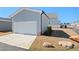 Exterior view of a detached garage with a paved driveway and landscaping at 236 Annabelle Blue Dr, Wake Forest, NC 27587