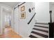 Bright hallway with wood flooring, a barn door, and stairs with dark treads and white risers at 236 Annabelle Blue Dr, Wake Forest, NC 27587