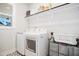 A functional laundry room featuring a side-by-side washer and dryer and storage shelves at 236 Annabelle Blue Dr, Wake Forest, NC 27587