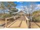 Community pier with wood railing and covered gazebo overlooking a pond with trees on a partly cloudy day at 236 Annabelle Blue Dr, Wake Forest, NC 27587
