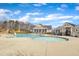 Community pool with wading area, lounge chairs, and a building with a covered patio on a sunny day at 236 Annabelle Blue Dr, Wake Forest, NC 27587