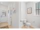 Clean powder room with a modern sink, toilet, and a decorative tile floor at 236 Annabelle Blue Dr, Wake Forest, NC 27587