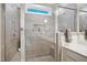 Modern tiled shower with a built-in niche, glass doors, and a herringbone pattern floor at 236 Annabelle Blue Dr, Wake Forest, NC 27587