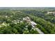 Aerial view highlighting the proximity of the property to nearby commercial buildings and water tower at 2409 Hodges Rd, Burlington, NC 27217