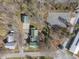 An aerial view shows the building complex, various homes, a parking lot, and some wooded areas at 2409 Hodges Rd, Burlington, NC 27217