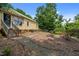 Inviting backyard featuring a fire pit with seating, ideal for outdoor gatherings at 2409 Hodges Rd, Burlington, NC 27217