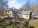 Aerial view of backyard features fencing, picnic table, and mature trees at 2409 Hodges Rd, Burlington, NC 27217