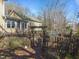 Backyard features wooden gate, picnic table, and a tranquil outdoor setting at 2409 Hodges Rd, Burlington, NC 27217
