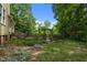 Backyard view of a charming backyard featuring a wooden fence and lush greenery at 2409 Hodges Rd, Burlington, NC 27217