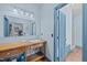 Well-lit bathroom featuring a long vanity and separate toilet and shower area at 2409 Hodges Rd, Burlington, NC 27217