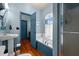 Bright bathroom with blue trim, tub, shower, and classic fixtures at 2409 Hodges Rd, Burlington, NC 27217