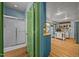 Bathroom and kitchen featuring blue walls, light cabinetry, and white appliances at 2409 Hodges Rd, Burlington, NC 27217