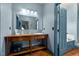Blue bathroom features custom wooden sink, vanity, and natural light at 2409 Hodges Rd, Burlington, NC 27217