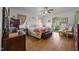 Bright bedroom with hardwood floors, large bed, and natural light streaming through the windows at 2409 Hodges Rd, Burlington, NC 27217