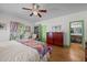 Cozy bedroom with hardwood floors, colorful quilt, and decorative accents for a charming atmosphere at 2409 Hodges Rd, Burlington, NC 27217