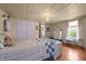 Bedroom features light colored walls, hardwood floors, and a window at 2409 Hodges Rd, Burlington, NC 27217