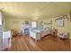 Bright bedroom features a yellow ceiling, wood floors, and a decorative fireplace with pink accents at 2409 Hodges Rd, Burlington, NC 27217