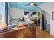 Bedroom with blue trim, hardwood floors, vintage furnishings, with a TV and fishtank at 2409 Hodges Rd, Burlington, NC 27217