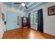 Bright bedroom with hardwood floors, blue ceiling, closet with mirror door, and ample natural light at 2409 Hodges Rd, Burlington, NC 27217
