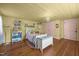 Charming bedroom features yellow ceiling, hardwood floors, and cozy furnishings at 2409 Hodges Rd, Burlington, NC 27217