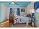 Charming bedroom with blue ceiling, colorful rug, and a window offering natural light at 2409 Hodges Rd, Burlington, NC 27217