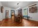 Dining room with wood floors, window bench and decorative elements; 'Come Gather At Our Table' sign above at 2409 Hodges Rd, Burlington, NC 27217