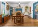 Charming dining room with wood floors and trim, featuring a decorative fireplace and ample natural light at 2409 Hodges Rd, Burlington, NC 27217