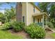 Side view of a charming two-story home with a brick chimney and covered porch with swing at 2409 Hodges Rd, Burlington, NC 27217