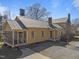 Quaint home with covered porch and mature trees on a sunny day at 2409 Hodges Rd, Burlington, NC 27217
