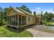 Exterior side view of home featuring a screened porch and lush landscaping at 2409 Hodges Rd, Burlington, NC 27217