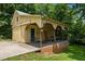 Charming yellow garage with brick foundation and covered side porch for workspace and tools at 2409 Hodges Rd, Burlington, NC 27217