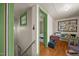 Hallway with wood floors offers a glimpse into the bathroom, showcasing vintage charm at 2409 Hodges Rd, Burlington, NC 27217